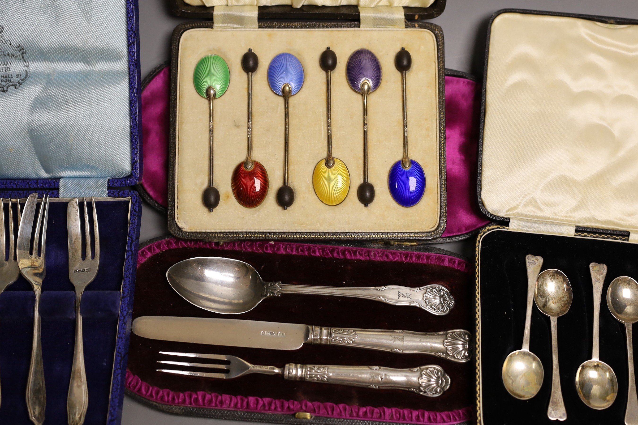 Four assorted cased sets of cutlery including a christening trio and a cased set of six silver and polychrome enamel, William Suckling Ltd. Birmingham, 1939.